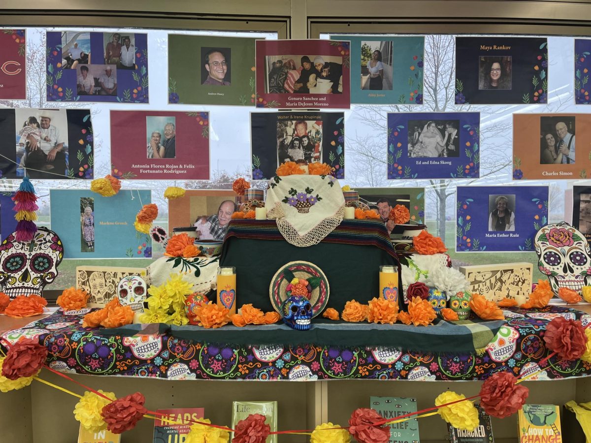 An ofrenda created by Plainfield Easts Latin American Student Organization to celebrate Day of the Dead or El Día de los Muertos. The ofrenda consists of flowers, pictures, and more.