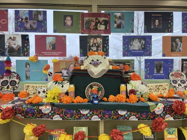 An ofrenda created by Plainfield Easts Latin American Student Organization to celebrate Day of the Dead or El Día de los Muertos. The ofrenda consists of flowers, pictures, and more.