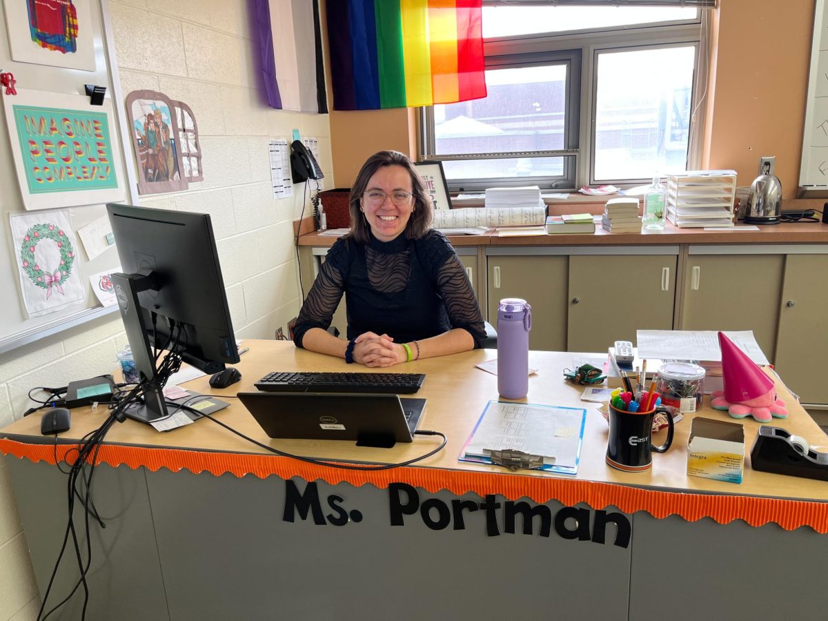 Erin+Portman+sits+at+desk+in+classroom+where+she+teaches+Rhetoric+and+AP+Language+and+Composition+at+Plainfield+East+High+School.