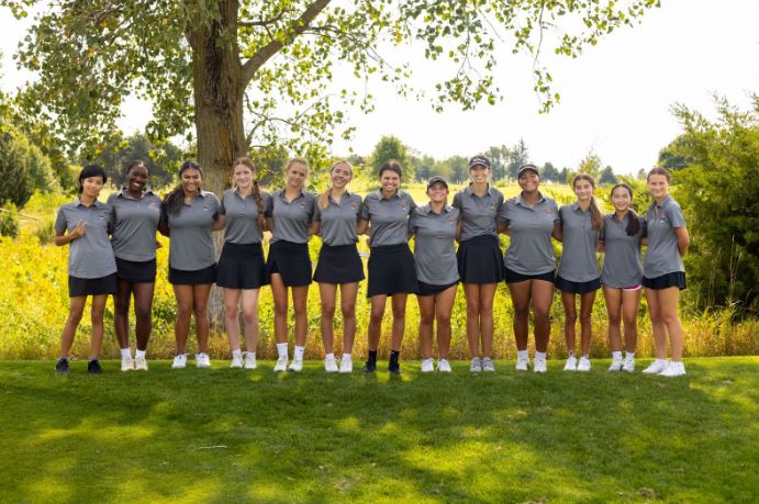 Girls JV and Varsity Golf pose for a photo during practice at the Naperbrook Golf Course