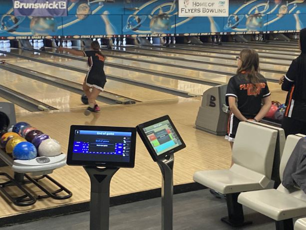 Chelsea Cabin, senior,  bowls in the Bengals’ match against Joliet Central on Thursday, Dec. 12 as Amber Bozych and Eman Hussain await their turn