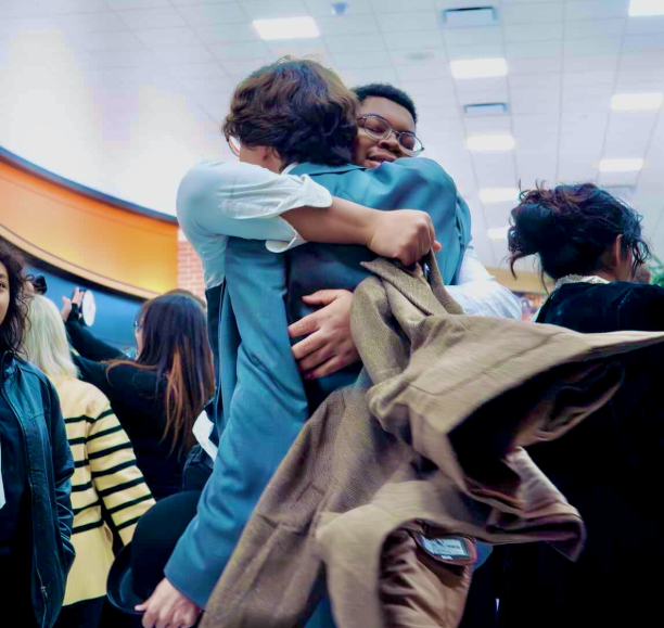 Stephen Odoi and Adam Dills embrace post performance. 