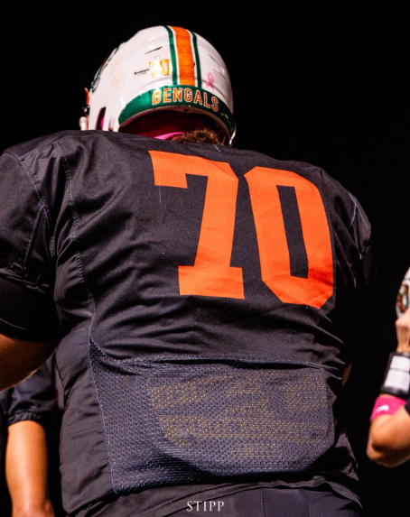 Cameron Murray playing for Plainfield East High School football post-injury.
